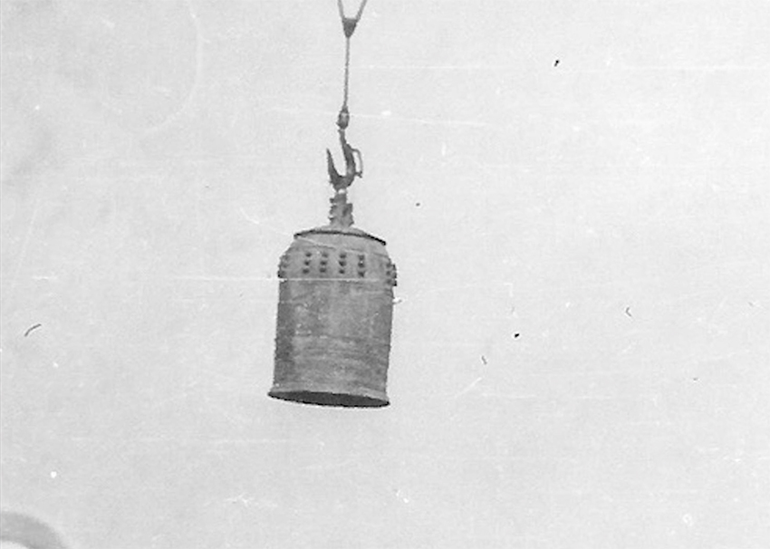 Historic photo of a Japanese bonsho temple bell moved by crane