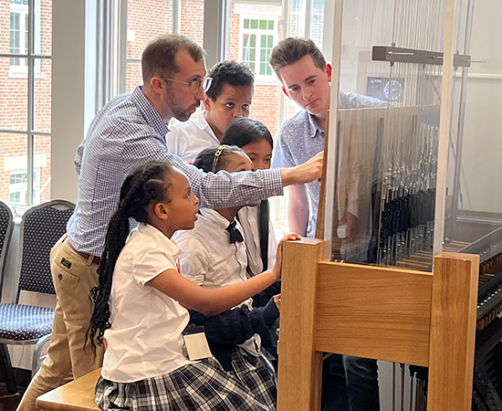 Students learn to play the carillon, an instrument of bells.