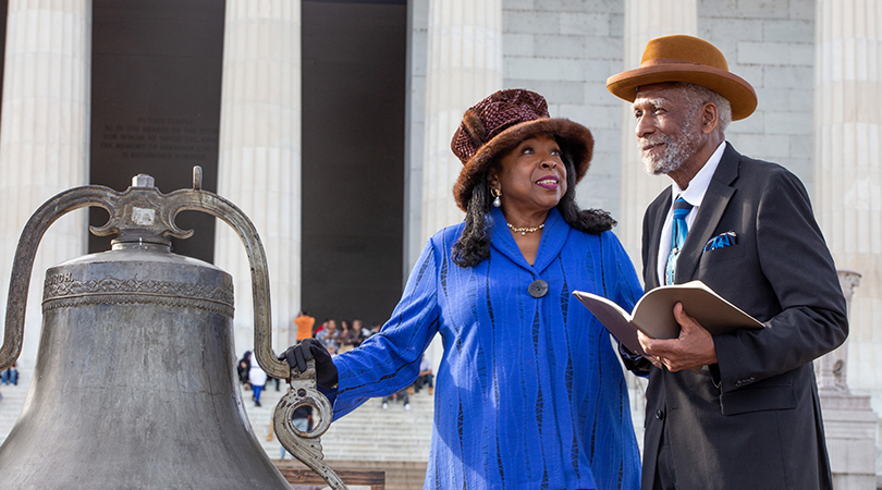 Dr. BJ Douglass and Frederick Douglass IV next to the 1863 Fulton bell on the steps of the Lincoln Memorial
