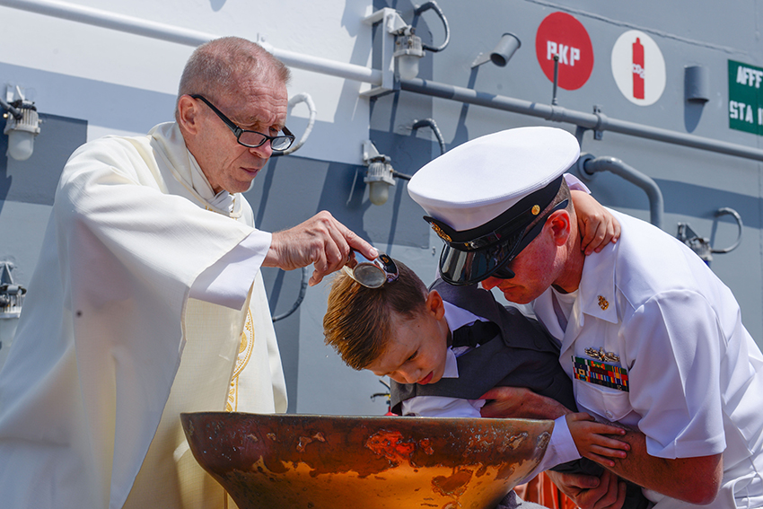 Son is baptized in a ship's bell