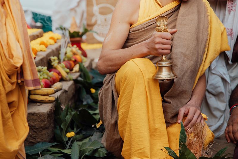 Vedic priest rings a bell during Hindu yagna fire ritual