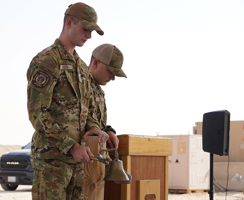 Airman 1st Class Nathan Horn rings a bell in honor of first responders during a 9/11 remembrance ceremony