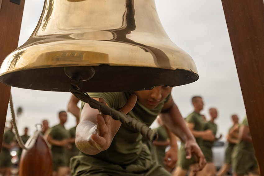 A new U.S. Marine rings the bell during a 3-mile motivational run