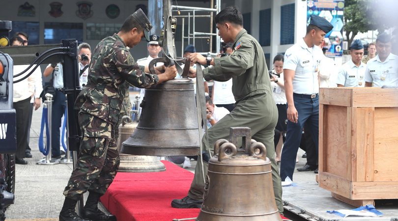 Bells of Balangiga are unloaded from a military transport plane in the Philippines