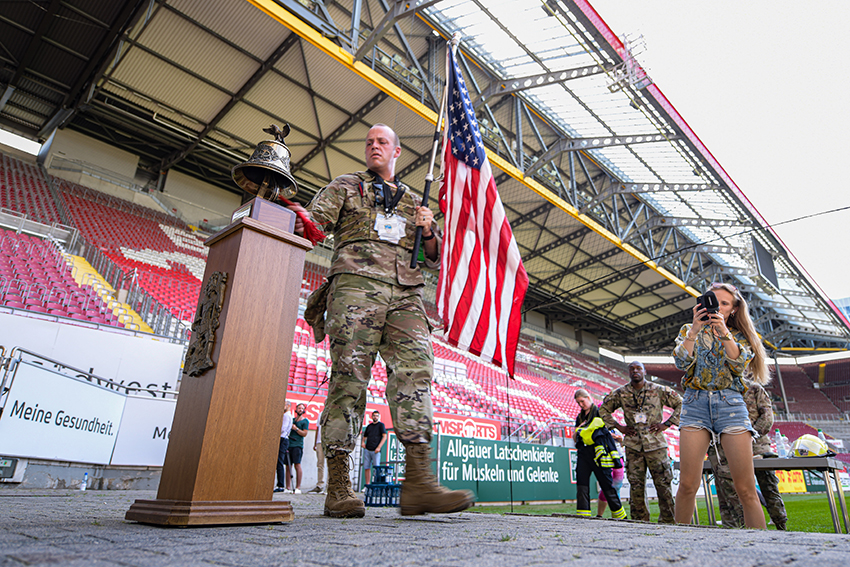 U.S. Air Force Lt. Col. Taylor Branco rings a ceremonial bell