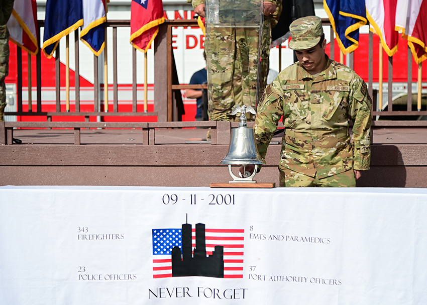 U.S. Air Force Airman Malaki Harrison rings the firefighter's bell during a 9/11 remembrance ceremony