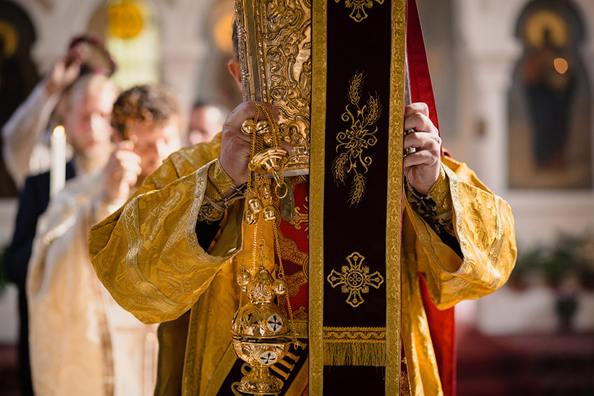 An Orthodox priest carries a censer with crotal bells