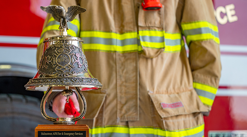 Firefighter rings a fire bell in memory of fallen hero