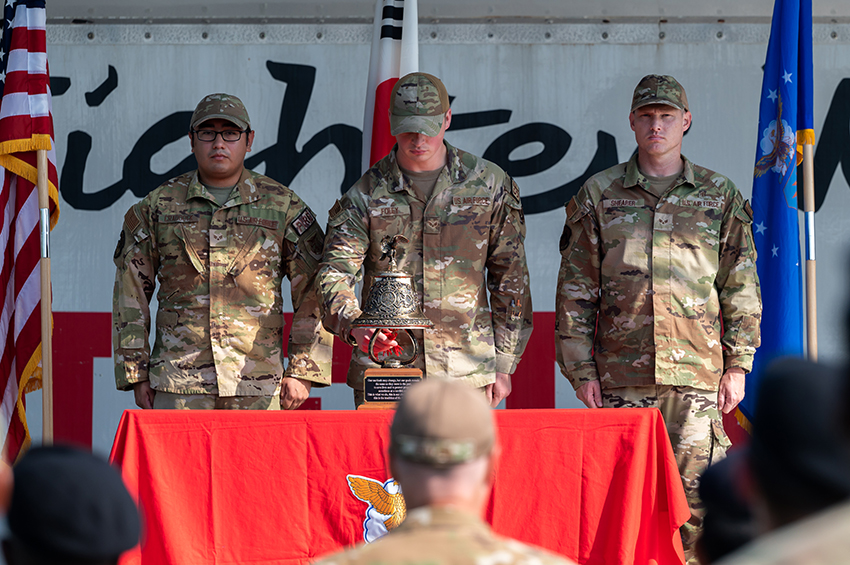 Airmen ring a bell during a 9/11 remembrance ceremony