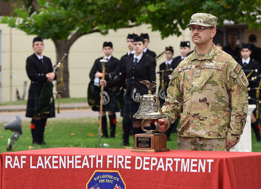 U.S. Air Force Senior Airman Emmanuel Rebollar rings a ceremonial bell