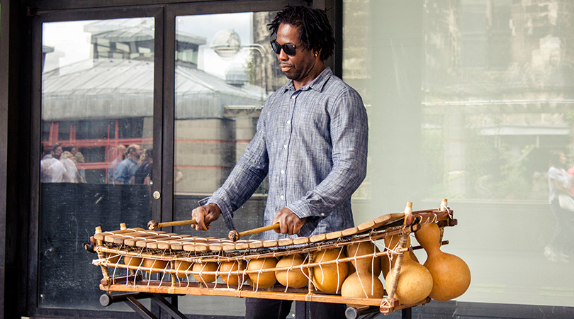 Man plays an idiophone from West Africa: the balafon