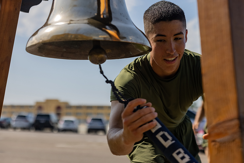 A new U.S. Marine with Mike Company rings the bell during a motivational run