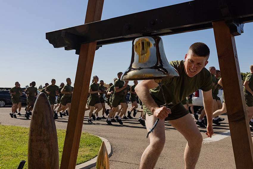 A new U.S. Marine with Kilo Company rings the bell during a 3-mile motivational run