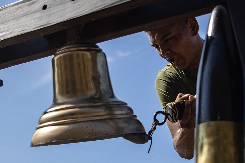 A new U.S. Marine with Hotel Company rings the bell during a motivational run