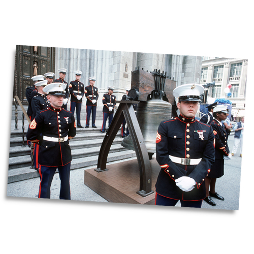 US Marines stand in formation around a bell during the 100th anniversary celebration of the Statue of Liberty.