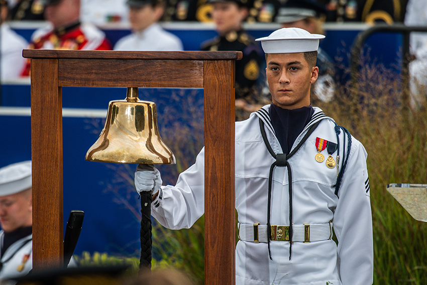 A U.S. sailor assigned to the Joint Force Honor Guard rings a bell