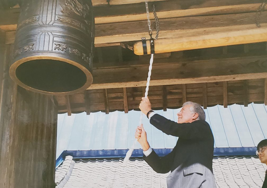 Former U.S. President Jimmy Carter rings the replica Peace Bell