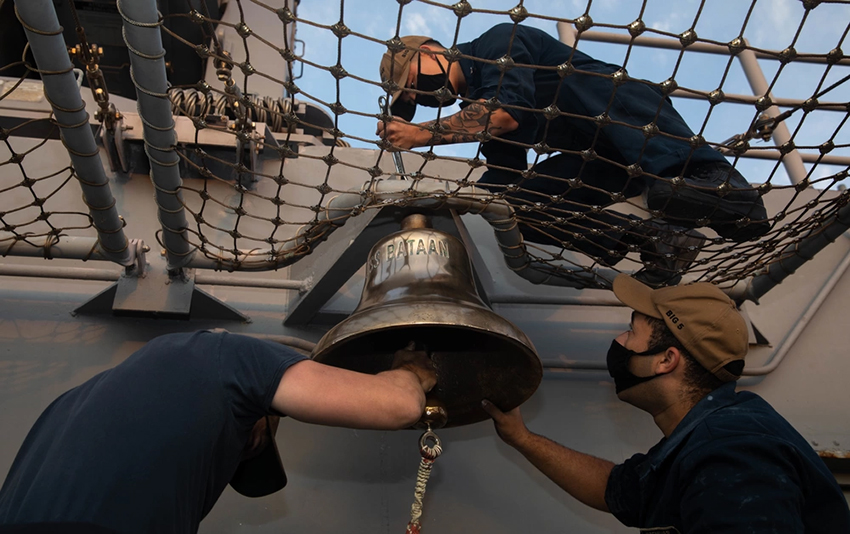 Sailors Remove a Ships Bell for Baptism