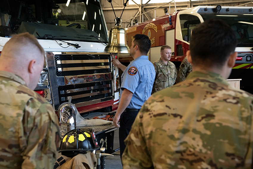 Members of the 628th Civil Engineer Squadron fire department ring a memorial bell