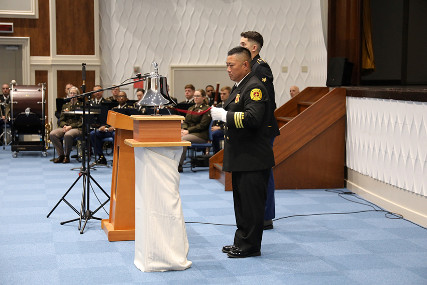 Shinji Kajita rings a bell to honor those who died in the attacks in 2001