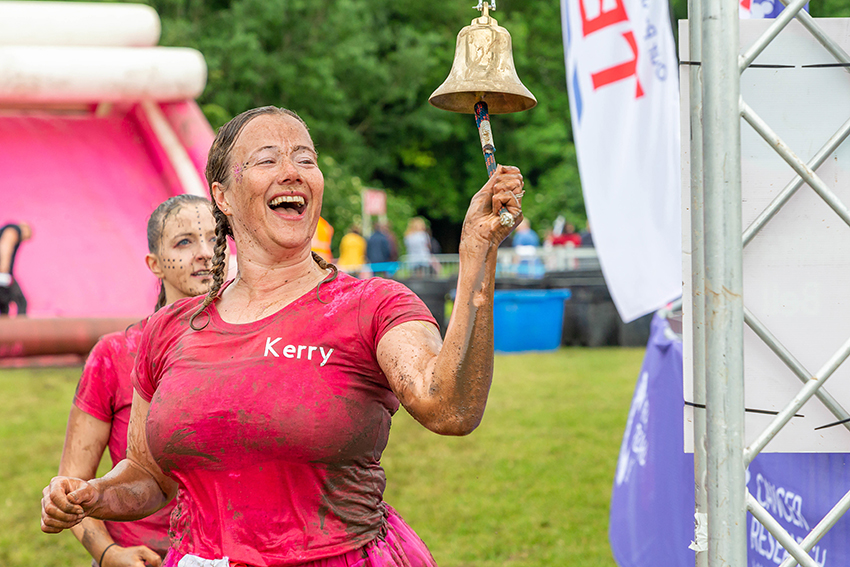 Woman rings a bell after relay to fund cancer research