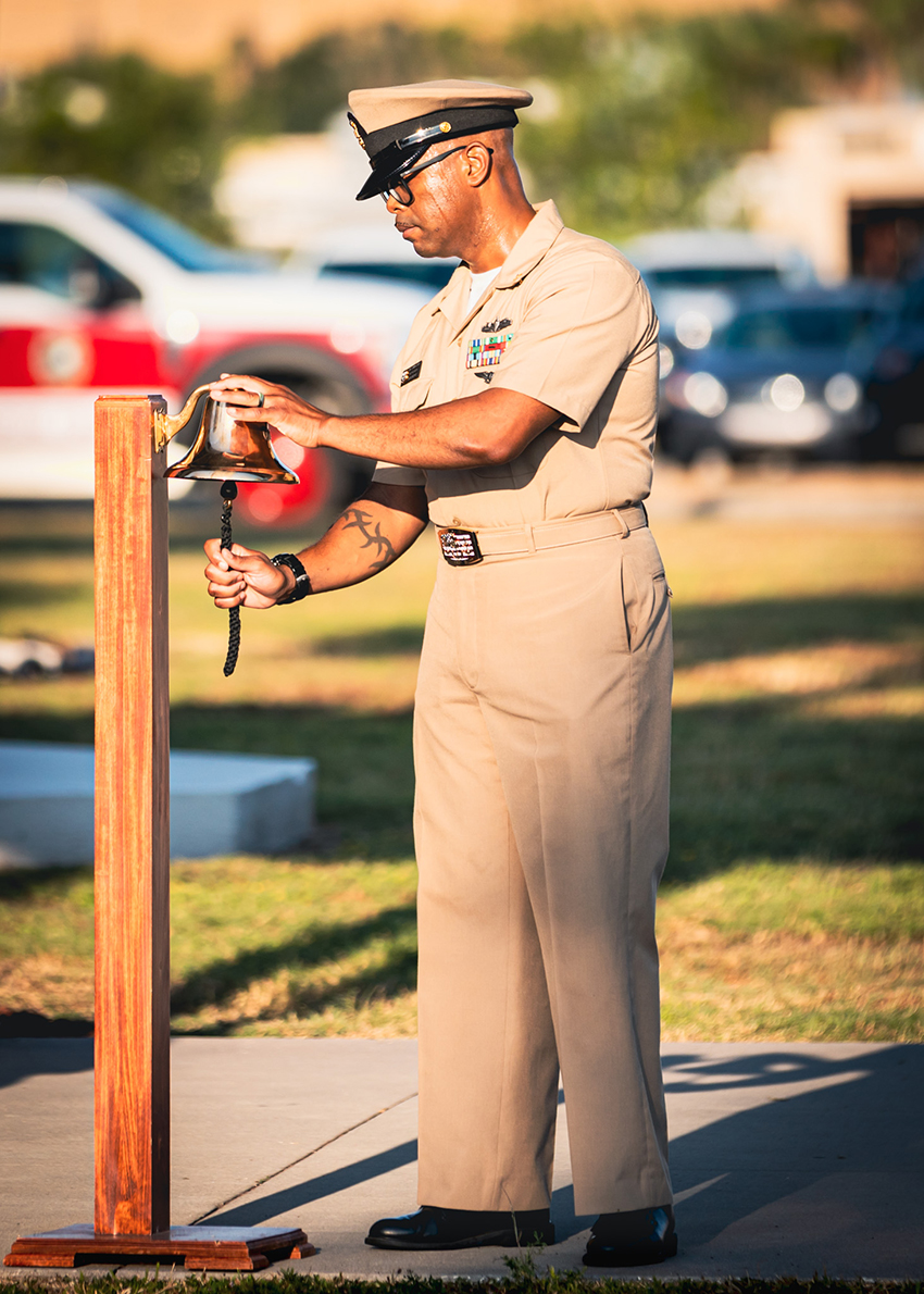 Senior Chief Boatswain's Mate Jason Brown, assigned to Naval Station Mayport, strikes the bell during a 9/11 remembrance ceremony