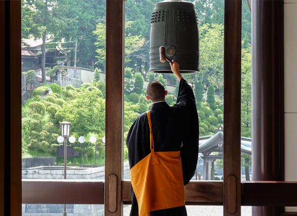 A Buddhist monk rings a bell to highlight the 2024 National Bell Festival spotlight nation of Japan