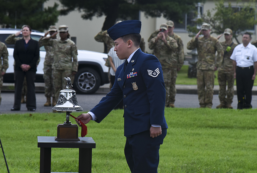 U.S. Air Force Staff Sgt. Enoch Ko rings a bell
