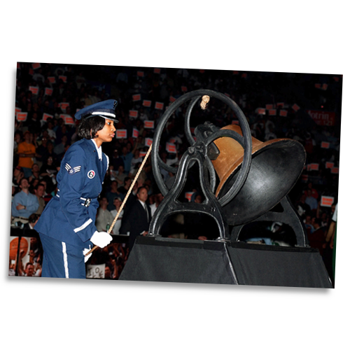 U.S. Air Force Senior Airman Nina Roulhac rings a replica Liberty Bell