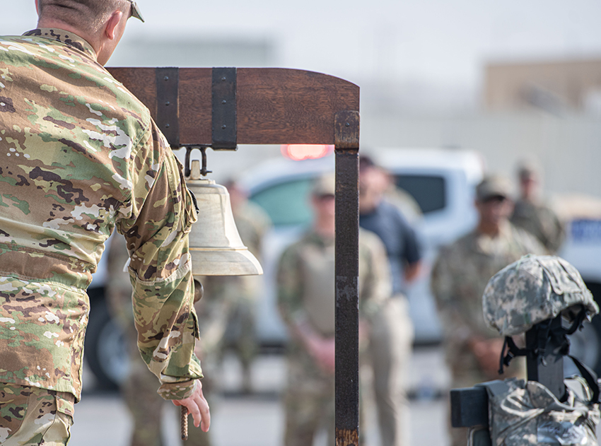 U.S. Air Force Senior Airman Elijah Zinselmeier tolls a bell during a 9/11 memorial ceremony