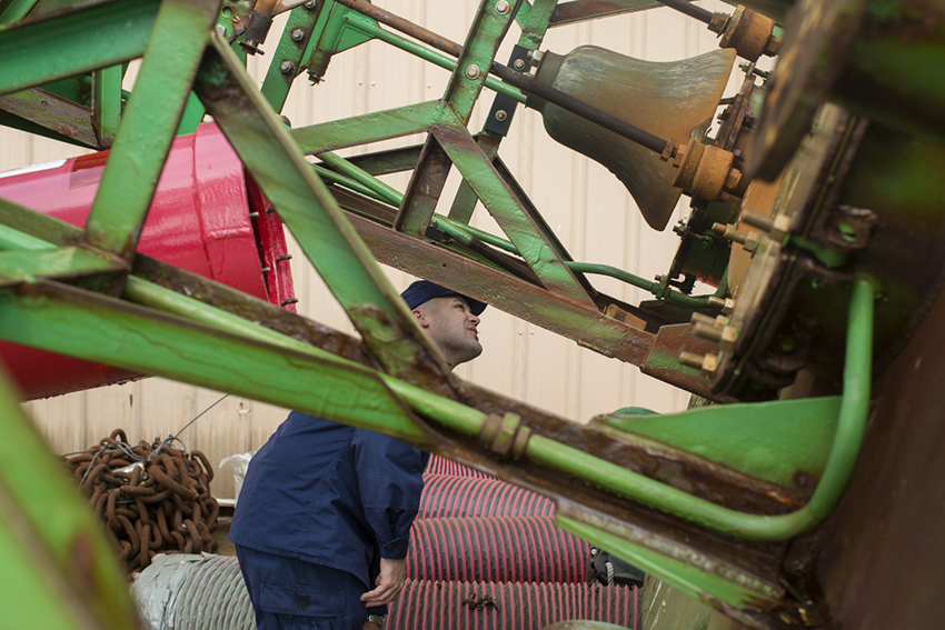 U.S. Coast Guard inspects a buoy bell