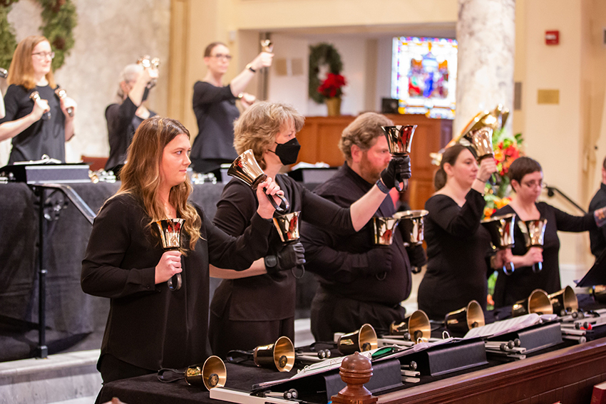 Members of the Virginia Bronze handbell ringing ensemble perform during the National Bell Festival